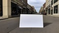 Large Blank Sign Lying On Street With Classic Architecture Storefronts Along Quiet Urban Roadway
