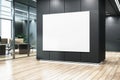 A large blank white poster on a black wall in an office lobby, wood floor, and glass, modern corporate branding concept. 3D Royalty Free Stock Photo