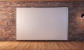A large blank whiteboard hangs on a brick wall in a modern office space Royalty Free Stock Photo