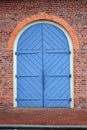 Large Blue Carriage Door in a Red Brick Wall