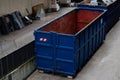 Large blue dumpster located in an urban industrial area Royalty Free Stock Photo
