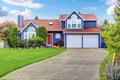 Large blue house with white trim and a nice lawn.