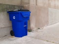 Large Blue Trash Can on a City Sidewalk Royalty Free Stock Photo