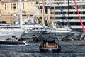 A large boat enters the port, the girl on the deck is talking on the phone, A lot of huge yachts are in port of Monaco
