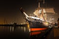 large boat sitting on a harbor next to a pier at night: Star of India, San Diego, CA