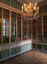 Large bookshelf and chandelier at Versailles Palace, France