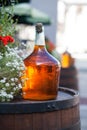 Large bottle of homemade wine are on the barrel