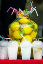 A large bottle of lemonade and glasses at the festival of street