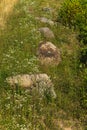 Large boulders on the grassy slope of the mountain in the rays of sunlight Royalty Free Stock Photo