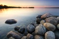 Large boulders on lake shore at sunset. Minnesota, USA