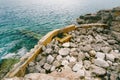 Large boulders and remains of a stone fence in the sea. Montenegro Royalty Free Stock Photo