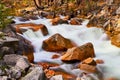 Large boulders in river with cascading waters