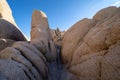 Large boulders and spires along the narrow trail, perfect for rock scrambling, inside of Joshua Tree National Park Royalty Free Stock Photo
