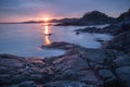 Large stones and the reflection of the sun in the waves of the sea at sunset / dawn Royalty Free Stock Photo