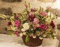 Large bouquet of flowers with a stone wall background