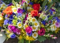 Large bouquet of summer wildflowers with poppies, daisies and cornflowers garnished with wheat ears closeup.