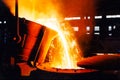 large bowl of molten metal at a steel mill. Steel production