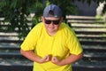 a large boy in a yellow T-shirt tenses his muscle. the concept of body positivity