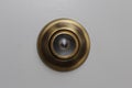 Large brass pinhole in a door Royalty Free Stock Photo