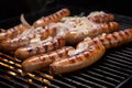 large bratwursts on a grill with beer and onion mix applied Royalty Free Stock Photo