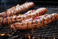 large bratwursts on a grill with beer and onion mix applied Royalty Free Stock Photo