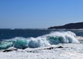 Large breaking wave hitting the shoreline with a big splash Royalty Free Stock Photo