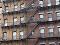 A large brick apartment building with lots of fire escapes. Royalty Free Stock Photo