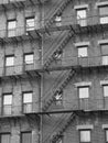 A large brick apartment building with lots of fire escapes. Royalty Free Stock Photo