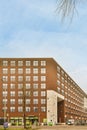 a large brick building with a blue sky above it