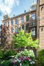 a large brick building with flowers in front of it