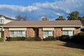 a large brick building with grass in front of a house