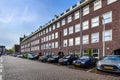 a large brick building with many cars parked in front