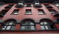 a large brick building with multiple arched windows with balconies Royalty Free Stock Photo