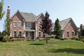 Large brick home with cedar roof Royalty Free Stock Photo