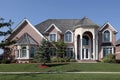 Large brick home with columned entryway Royalty Free Stock Photo