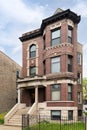 A large brick home with a concrete stairway.