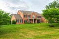 Large brick House in American suburb. Beautiful house with green lawn