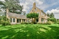 a large brick house with a lawn and a garden Royalty Free Stock Photo