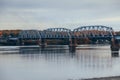 Large bridge over the river with metal structures and concrete supports