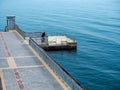 A large bridge with a pier and jumping and walking people in Burgas, Bulgaria