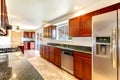 Large bright kitchen with dark cherry cabinets.