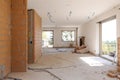 Large bright room with windows of an ancient villa undergoing renovation. The old walls have been torn down and new ones have been