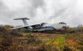 Large broken airliner on a field