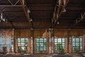 Large broken window in abandoned ruined industrial warehouse or factory building inside, ruins and demolition concept Royalty Free Stock Photo