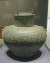 large bronze kettle with a pattern of clouds