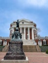 Large bronze statue stands atop a set of brick steps in a University of Virginia Rotunda