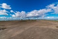 Large brown land area under a bright blue sky