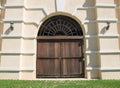 Large brown wooden door and beige wall Royalty Free Stock Photo