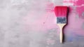 A large brush in bright paint on a gray-pink canvas Royalty Free Stock Photo