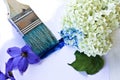 A large brush draws a hydrangea flower in blue Royalty Free Stock Photo